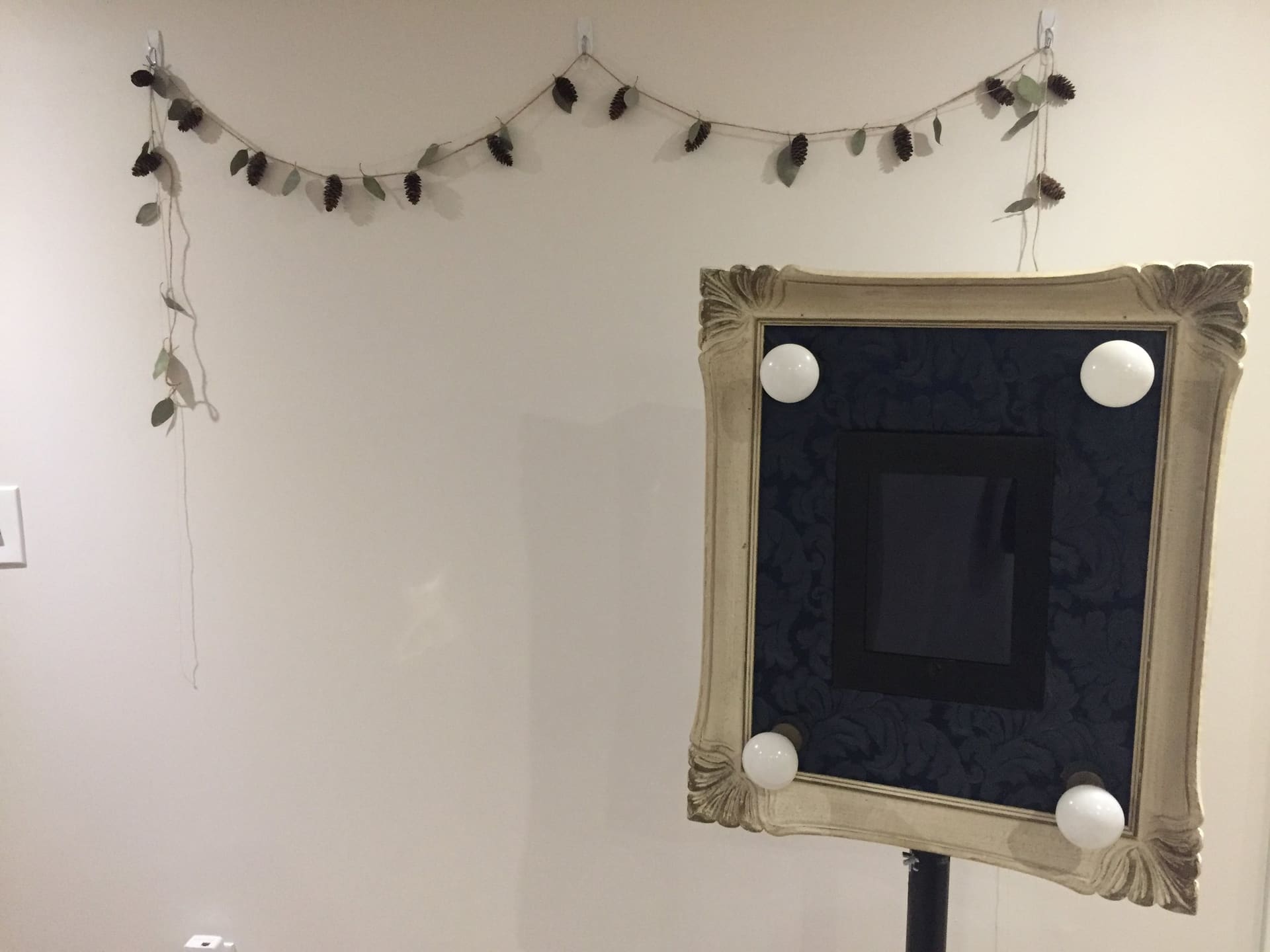 London Photo Booth's open-air booth with its lit frame and iPad