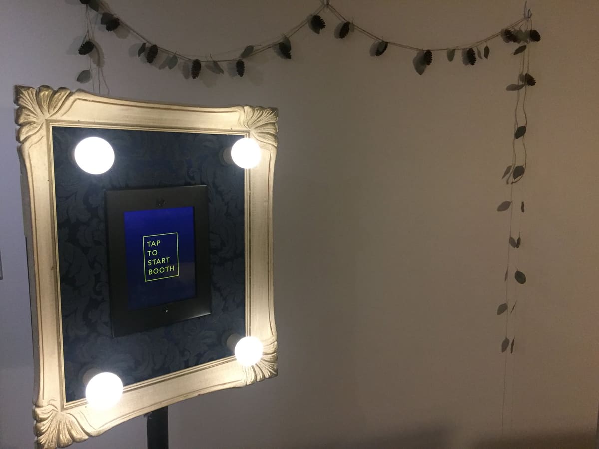 Open-air photo booth with its Tap to Start screen lit up